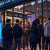 people standing out side a vape shop